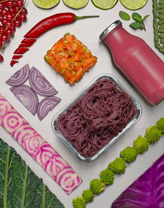 Different fresh food and drinks displayed on a silver background